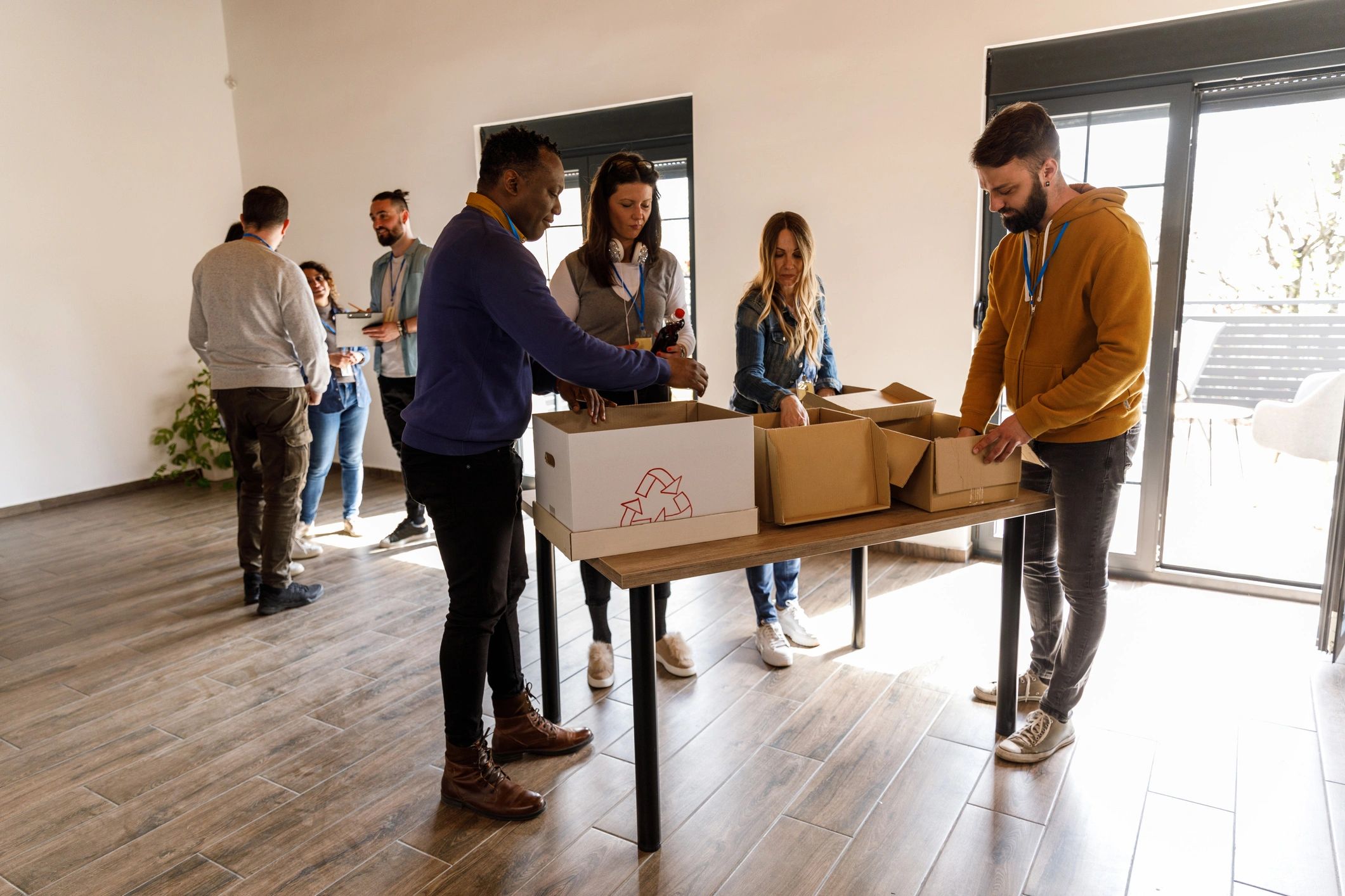 Volunteers sorting donation boxes for charity support