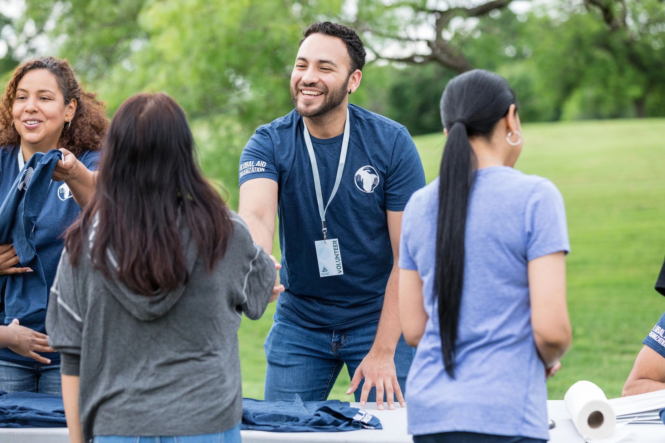 Volunteer greeting a community outreach participant with a handshake